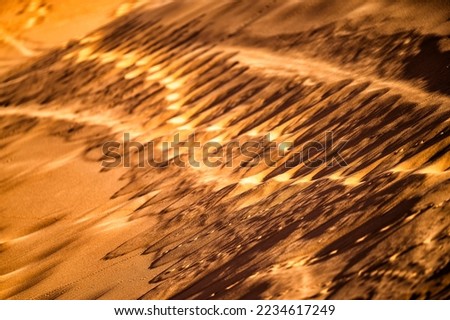 Desert sand dunes close-up background. Sahara Desert, Erg Chebbi, Morocco.