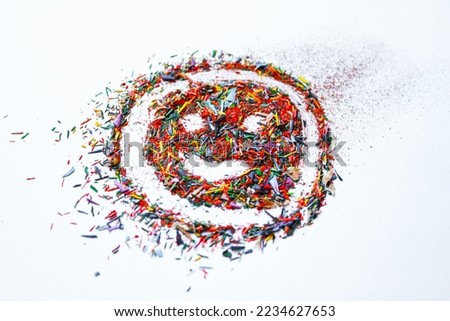 Crayon shavings on white background. Multicolored particles of colored pencils, close up, selective focus