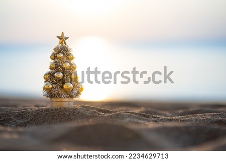 Christmas tree in silver and gold beautiful sunset on the beach, Christmas banner, Christmas banner, happy concept, copy space, soft focus