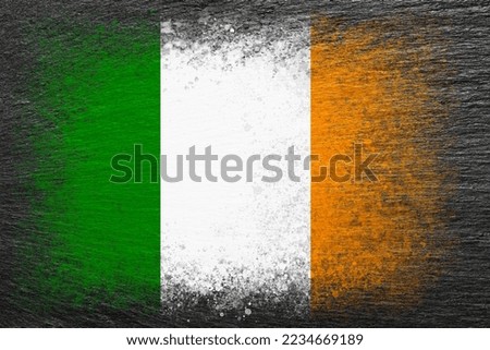 Flag of Ireland. Flag is painted on black slate stone. Stone background. Textured creative background