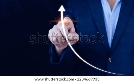 Businessman pointing touching growth on up arrow chart icon, hands touch the up arrow that represents profit rises, monetary growth