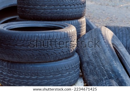 Heap of the different old used truck and car tires with worn treads outdoors, fragment close-up 
 Royalty-Free Stock Photo #2234671425