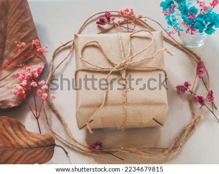 Brown gift box and flowers, leaves, decoration for New Year and Christmas.