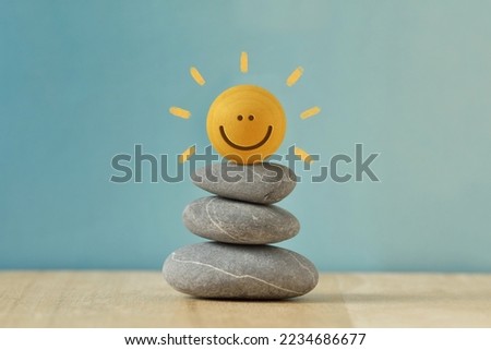 Stacked Zen stones with Happy round face - Concept of mental balance and positivity