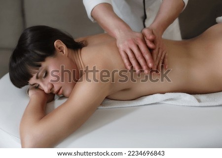 Pleasure of manipulation Ayurvedic massage therapist working on the Back of a woman greased with scented and warm oil. Alternative ayurveda ayurvedic body business card closeup concept conscio