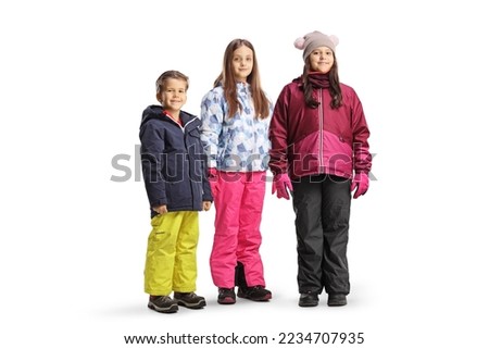 Two girls and a boy wearing winter clothing isolated on white background