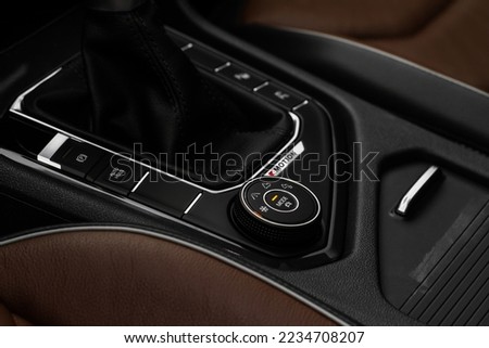Drive selector button. Car interior, offroad drive controller closeup view. Wheel drive selection. Four-Wheel Drive transmission selection system.  Royalty-Free Stock Photo #2234708207