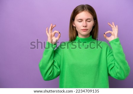 Young English woman isolated on purple background in zen pose