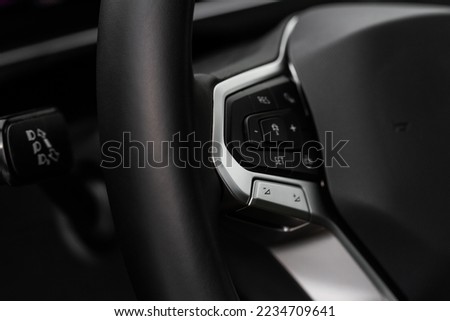 Cruise control switch closeup. Adaptive cruise control leaver. Cruise control on steering wheel. Royalty-Free Stock Photo #2234709641