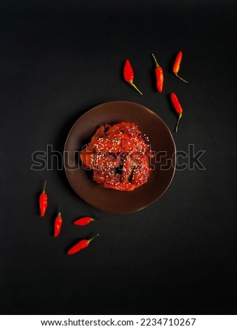 Fire spicy chicken wings with chili sauce glaze Royalty-Free Stock Photo #2234710267