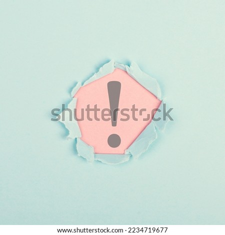 Exclamation mark surrounded by torn paper, alert sign, information and warning concept