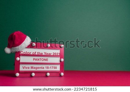 Magenta Color Cinema Vintage Lightbox With Small Santa Claus Hat On Tidewater Green Color Backdrop. Color Of The Year 2023. Pantone Color Institute. Viva Magenta