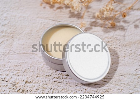 colorful lip balms in round tin cases on light background with shadow overlay, mockup design, label Royalty-Free Stock Photo #2234744925