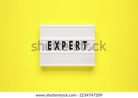 Lightbox with word expert on yellow background. Can be used for business and financial concepts.
