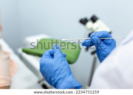 Vaginal Smear. Close-up of doctor hand holds gynecological examination instruments. Gynecologist working in the obstetrics and gynecology clinic. Royalty-Free Stock Photo #2234751259