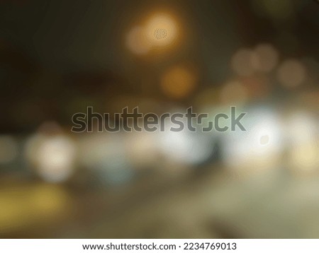 Blurry background image of city street lights at night

