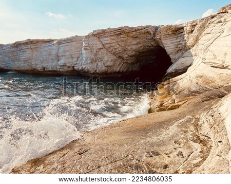 Mediterranean Sea scape white cave rocks with huge ocean waves in Monagroulli, Cyprus