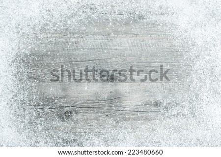 Old wooden board with snow flakes. Christmas background