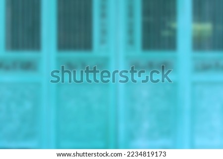 blurred background of old wooden carved green door use as backdrop