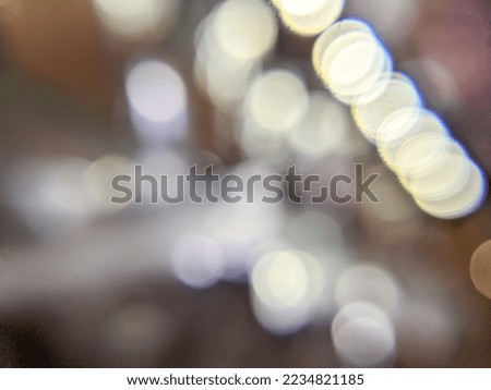 Blurred photo of stainless teapot and Christmas lights.