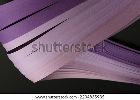Violet color strip wave paper on black. Abstract texture background.