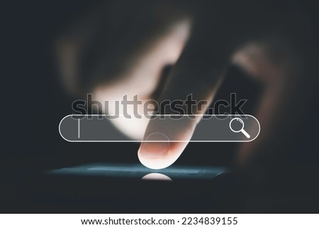 Hand touching to smartphone with searching bar icon for Search Engine Optimisation or SEO concept to find information by internet connection.