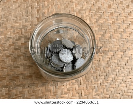 A jar of Indonesia rupiah coins 