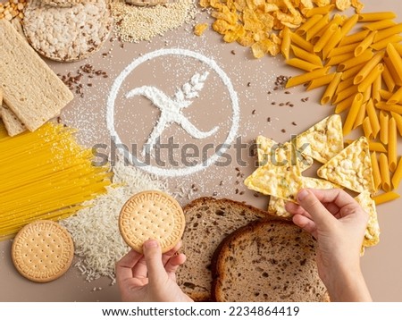 Gluten free food concept. Child hands holding gluten free snacks with symbol crossed sprinkle 