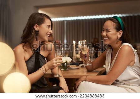 Friends, champagne and women in restaurant, party and dinner for bonding. New Years, females and girls enjoy drink, smile and conversation for celebration, bond and happy at social event to relax.
