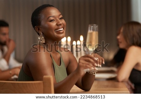 Champagne, celebration and happy black woman at a party or dinner at a table in the dining room. Happiness, smile and African lady enjoying a glass of alcohol beverage at a new year event at a house. Royalty-Free Stock Photo #2234868513