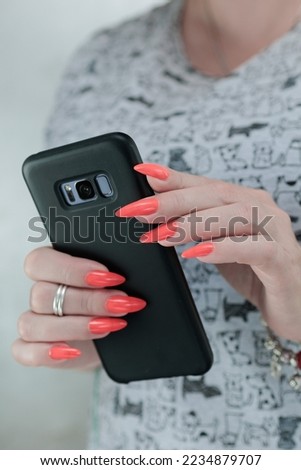 Woman's hands holding a large black smartphone	