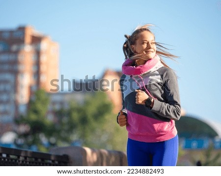 Photo of a 30-year-old woman jogging in the morning. The concept of a healthy lifestyle and keeping yourself in good shape.
