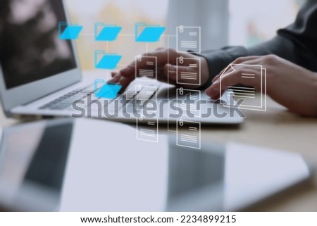 Electronic document management. Woman working on laptop at table, closeup