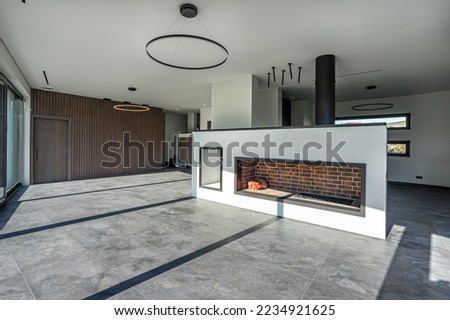 
empty hall without furniture of a modern country house with a fireplace