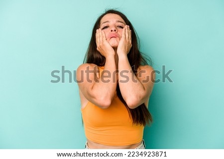Young caucasian woman isolated on blue background whining and crying disconsolately. Royalty-Free Stock Photo #2234923871