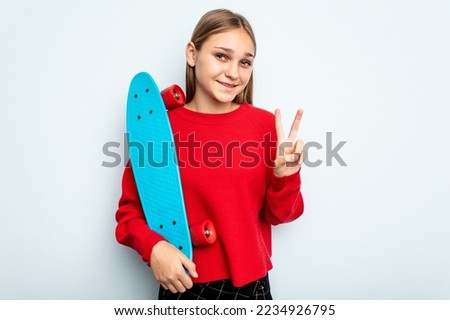 Young skater caucasian girl isolated on blue background showing number two with fingers.