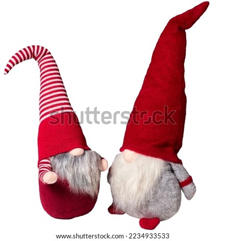 Christmas gnomes or elves in a red cap of different height. Close-up isolated on white