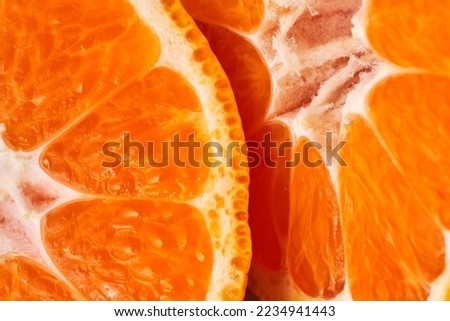 sliced sweet ripe tangerine close-up , macro photo , delicious and healthy citrus fruit , vitamin concept Royalty-Free Stock Photo #2234941443