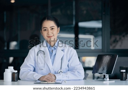 Medicine doctor with digital medical interface icons on hospital ICU corridor interior blur background, Medical technology and healthcare professional concept.