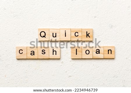quick cash loan word written on wood block. quick cash loan text on table, concept.