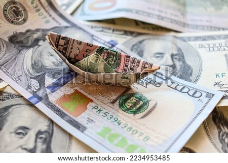 Dollar bills laid out on the table. A ship from a dollar on hundred dollar bill, financial crisis, money, finance, savings, salary, bank. Photo, macro photography