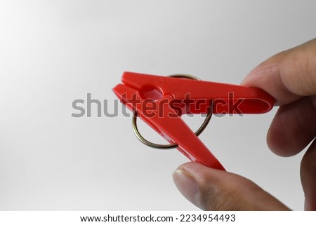 Red plastic clothespin isolated on white background. Plastic clips