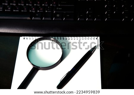  magnifying glass on the  laptop keyboard