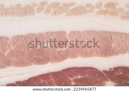 Raw bacon texture as a background. A close shot of raw bacon. Macro photo.bacon.