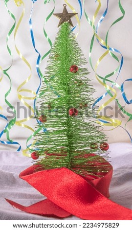 Christmas tree with a ribbon clothesline in the background with the colors of Brazil, brazilian festive Christmas concept,