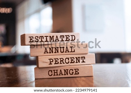 Wooden blocks with words 'ESTIMATED ANNUAL PERCENT CHANGE'.