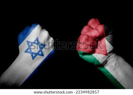 ISRAEL VS IR IRAN. Strong men hands painted country flags in fighting signal black background. Countries with social, economic, political, cultural, territorial, sports, financial conflicts. Royalty-Free Stock Photo #2234982857
