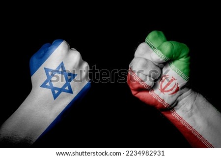ISRAEL vs IR IRAN. Strong men hands painted country flags in fighting signal black background. Countries with social, economic, political, cultural, territorial, sports, financial conflicts. Royalty-Free Stock Photo #2234982931