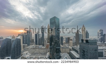 Panorama of futuristic skyscrapers with sunset in financial district business center in Dubai on Sheikh Zayed road timelapse. Aerial view from above with colorful cloudy sky