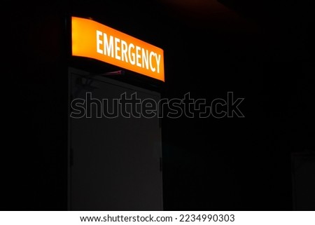 Hospital emergency department entrance sign at night.